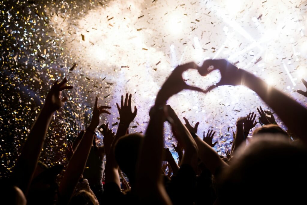 Portrait of happy crowd enjoying at music festival under streamer cannon rental in Dubai, UAE by Ppshot SFX